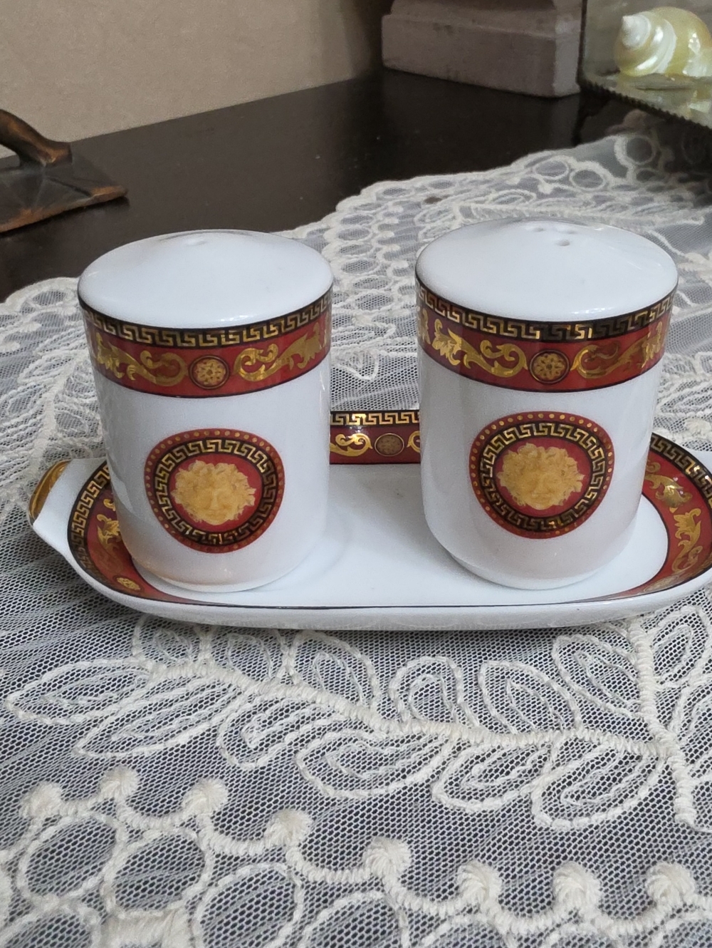 Elegant White Ceramic Salt and Pepper Set with Red and Gold Medallion